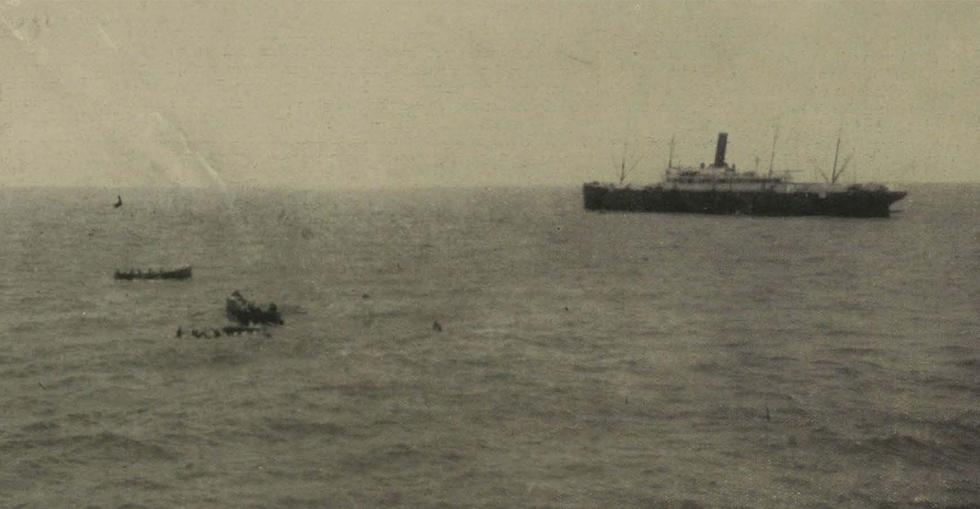 Boats picking up men in the water