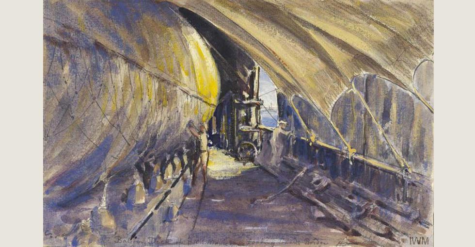 A view of the balloon deck of HMS Manica with the kite balloon being inflated underneath a tarpaulin that is attached to the deck rails on the sides of the ship. By Herbert Hillier.